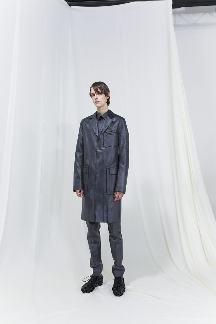 Model wearing dark grey long blazer and matching long trouser